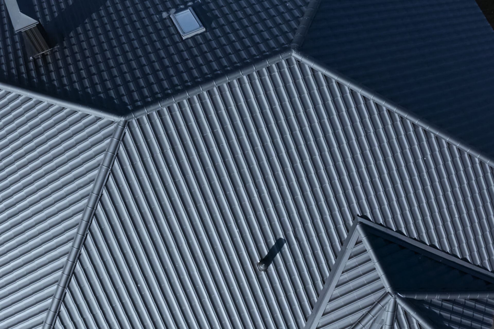An aerial view of a metal roof with a bird on it.