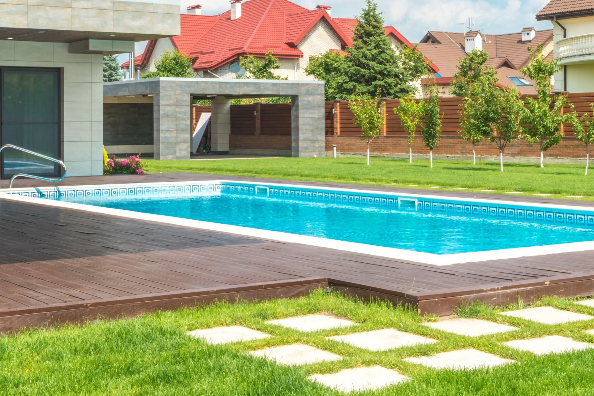 A large swimming pool in the backyard of a house