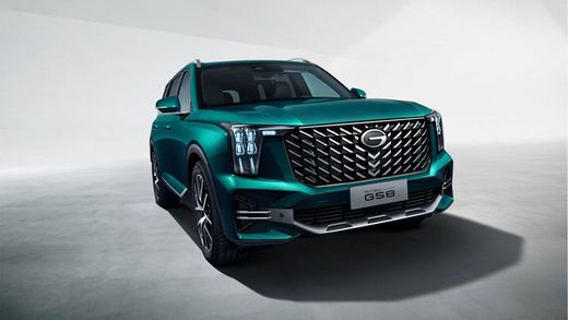 Teal SUV parked on a studio backdrop, front three-quarter view