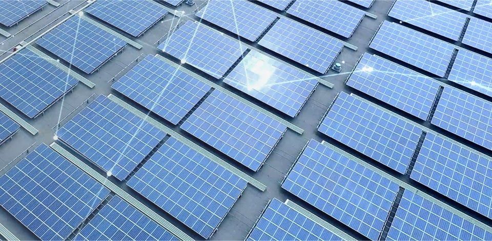 Blue solar panels arranged in rows, reflecting sunlight on a rooftop