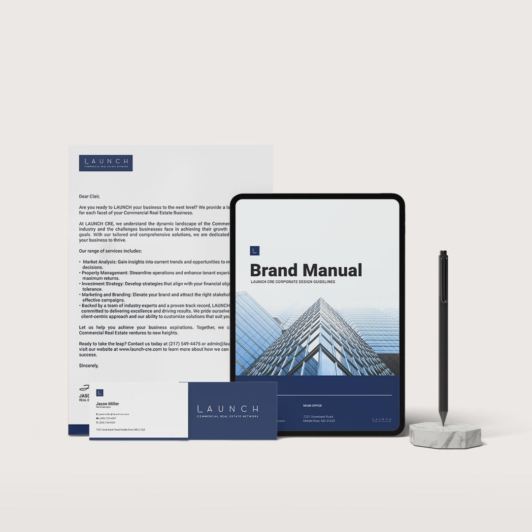 Branding materials including a letterhead, business card, tablet with brand manual, and pen. Navy blue and white color scheme.