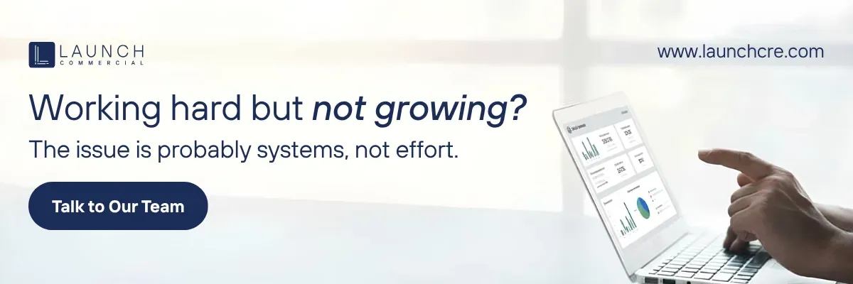 A man points at a smartphone beside text: “Working hard but not growing? The issue is probably systems not effort.”