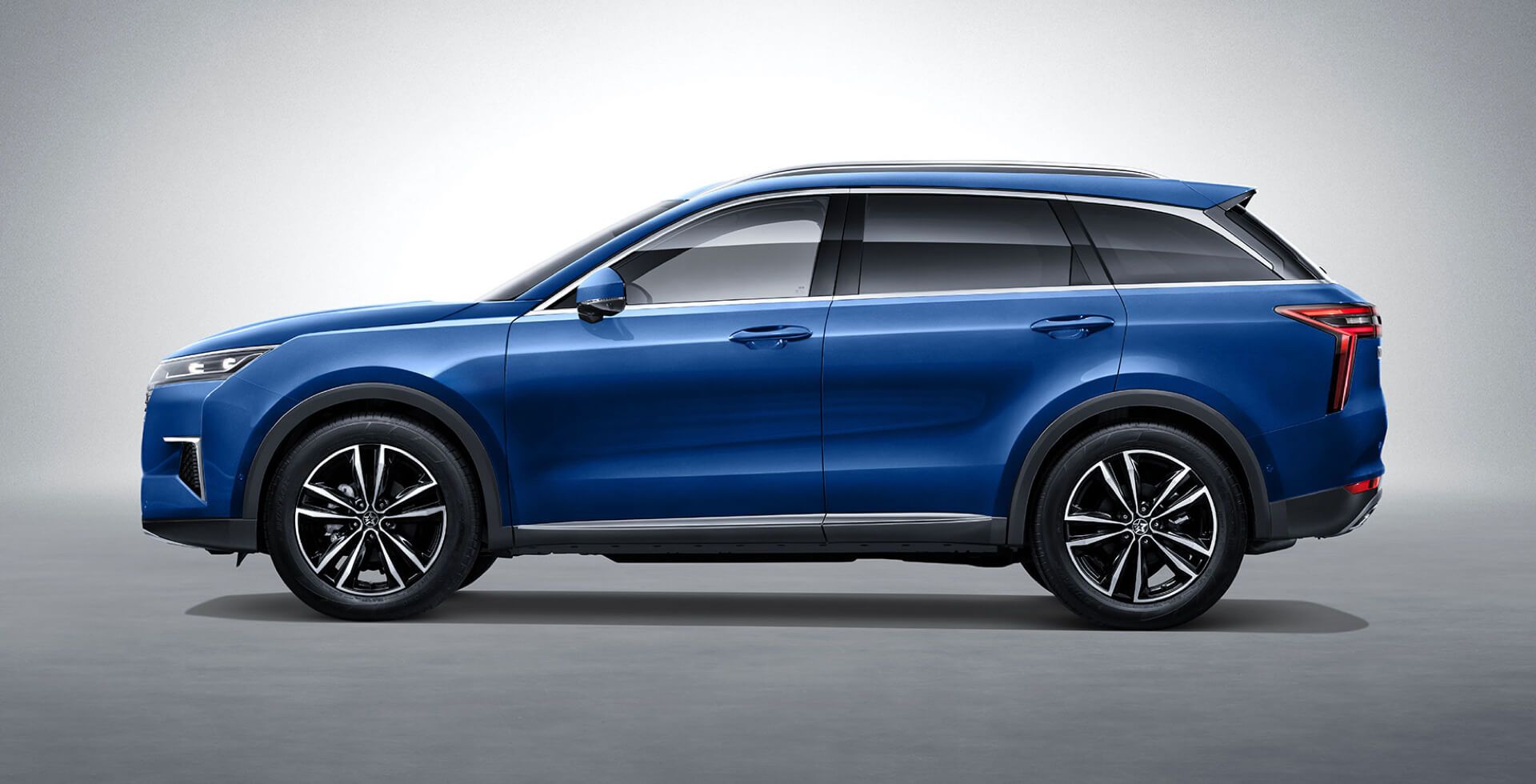 Blue SUV with black wheels on a white background.