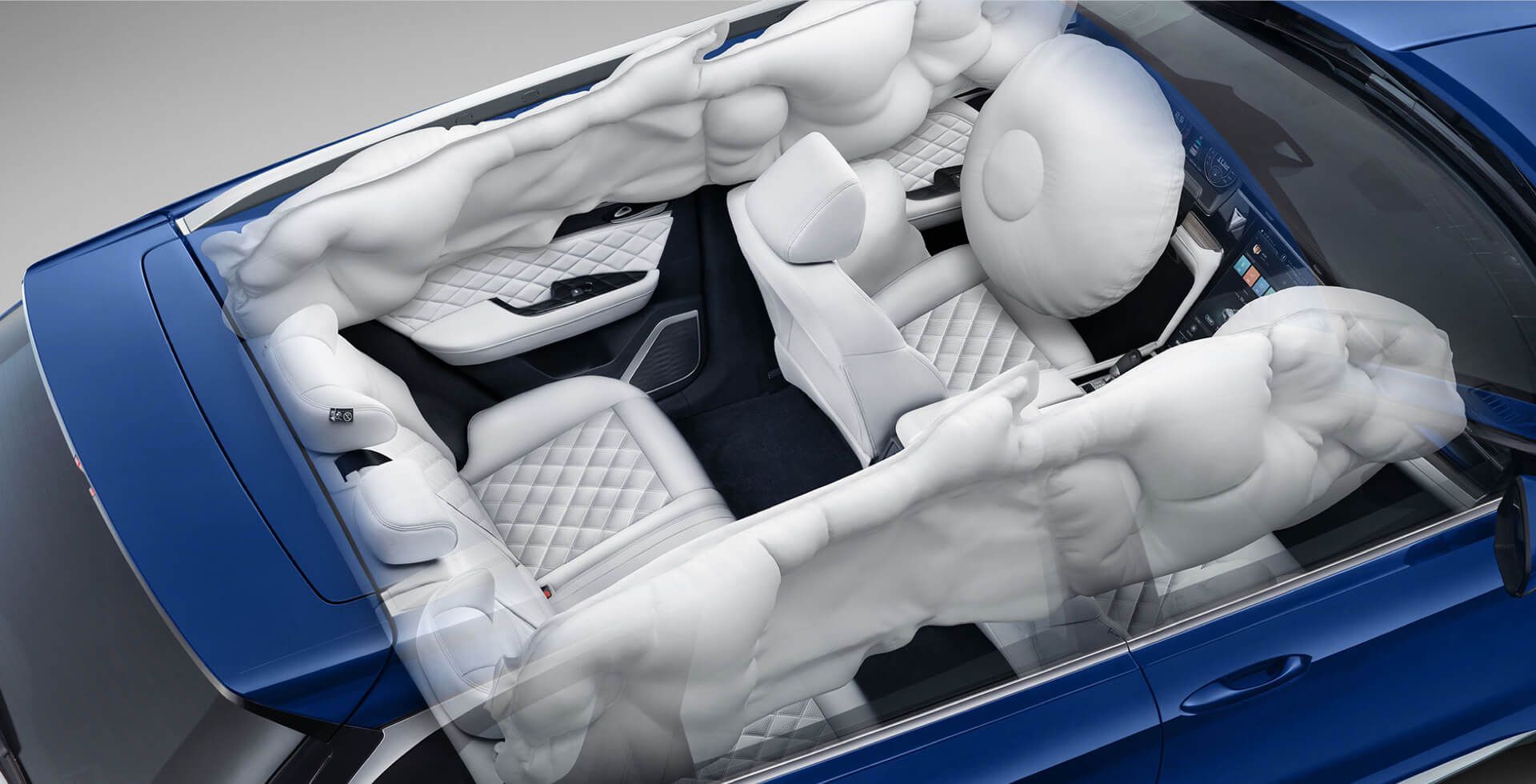 Car interior with airbags deployed after a collision, blue vehicle.