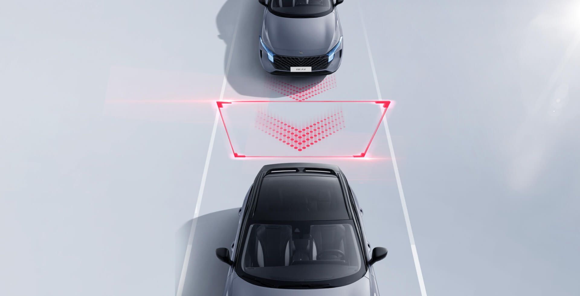 Overhead view of cars on a road. A red sensor graphic indicates potential hazards ahead.