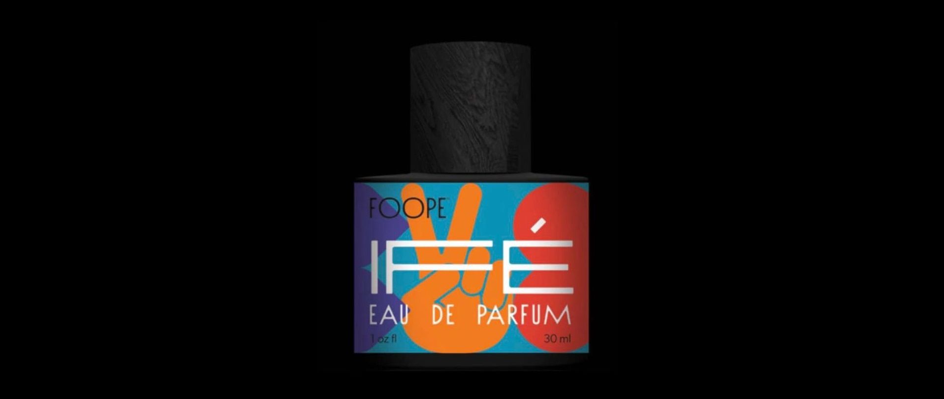 A bottle of perfume with a peace sign on it