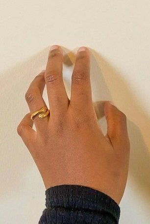 Hugger A person is wearing a gold ring on their left hand.