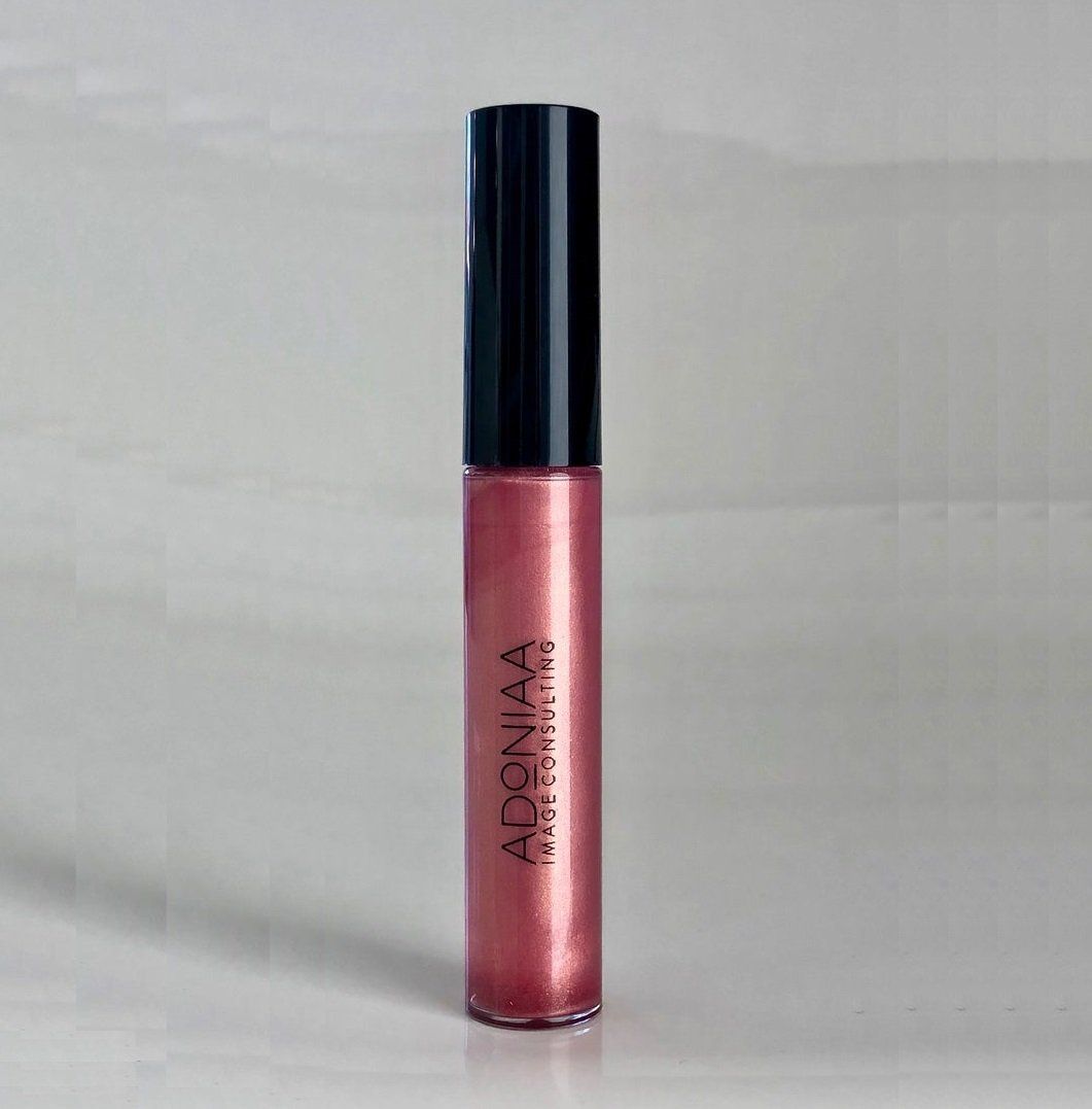 A bottle of adenaa lip gloss is sitting on a table