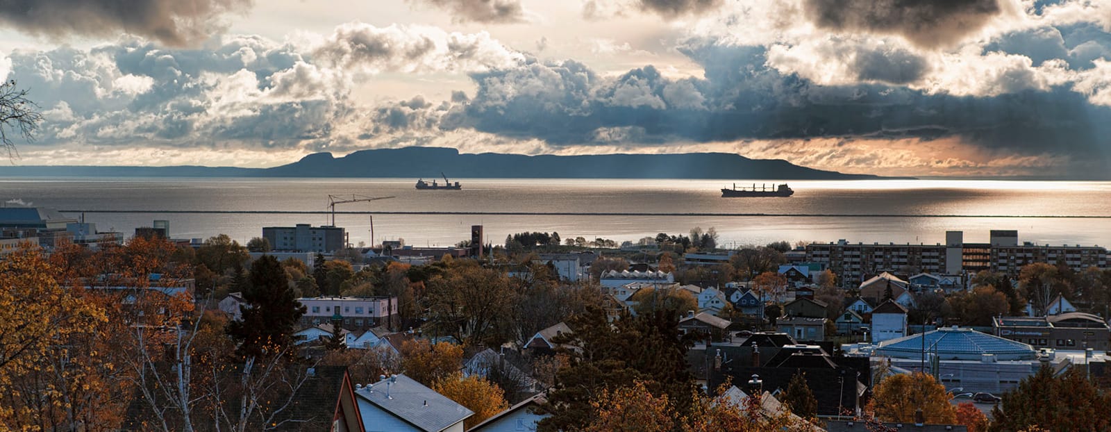 An aerial view of a city with a large body of water in the background.