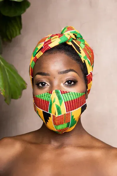 A woman wearing a headband and a face mask.
