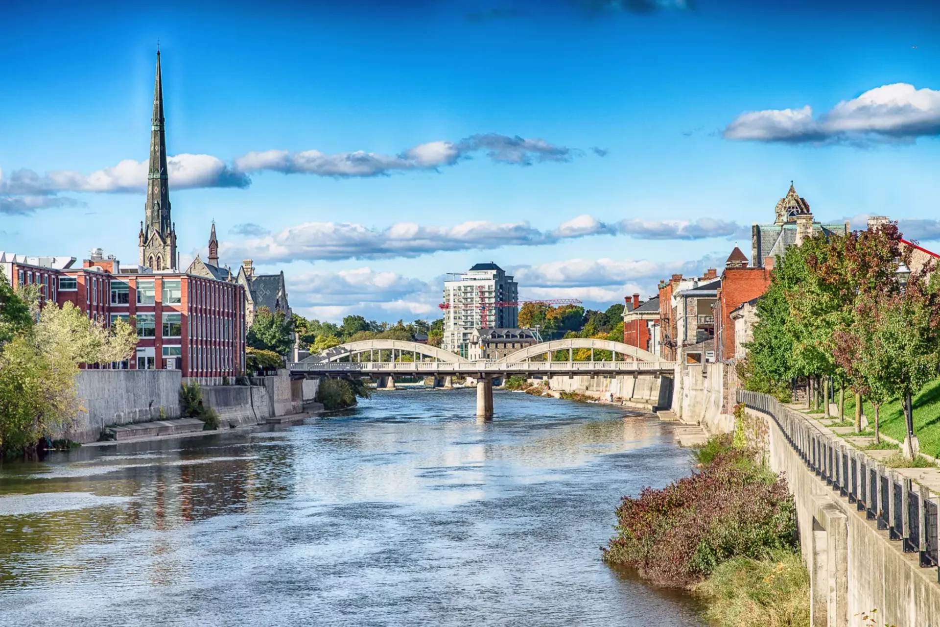 There is a bridge over a river in the middle of a city.