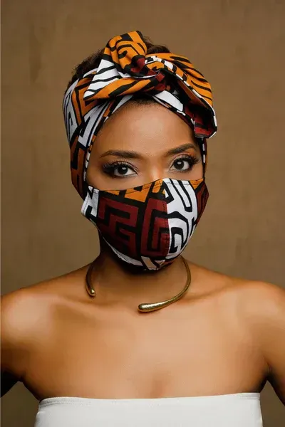 A woman wearing a headband and a face mask