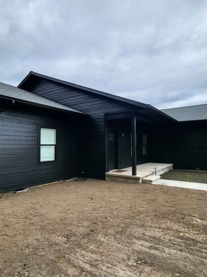 New construction home exterior with siding painted in dark tones