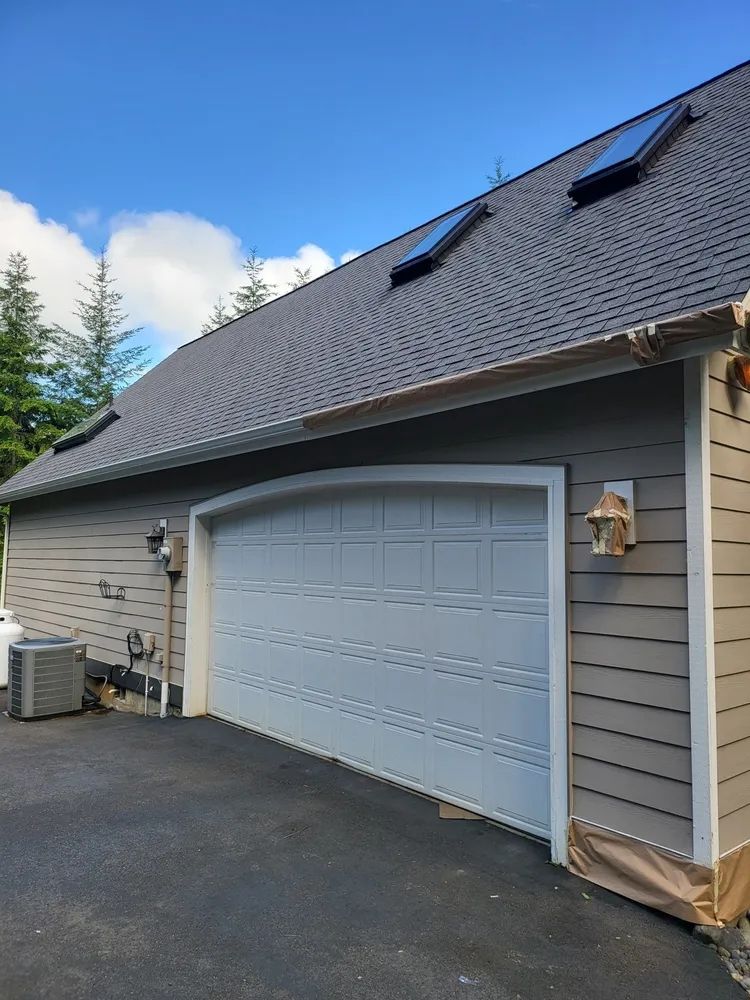 Residential garage before exterior painting and trim updates