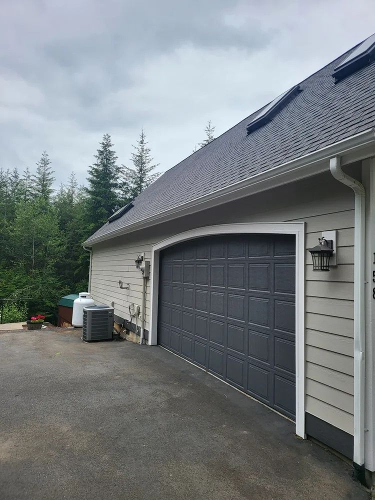 Freshly painted garage door, siding, and exterior trim