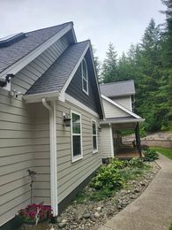 Exterior house painting with freshly painted siding, trim, and entryway