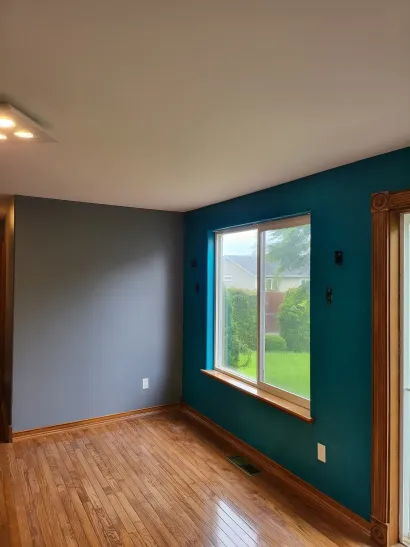 Freshly painted teal accent wall in a home interior