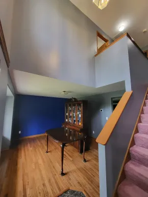 Interior painting with modern blue accent wall and staircase