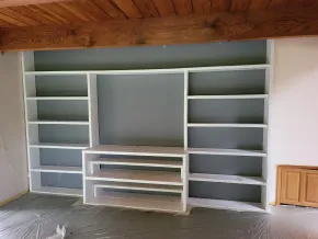 Custom built-in shelving with professionally refinished painted finish