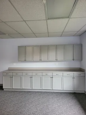 Completed kitchen cabinet refinishing with freshly painted gray cabinets