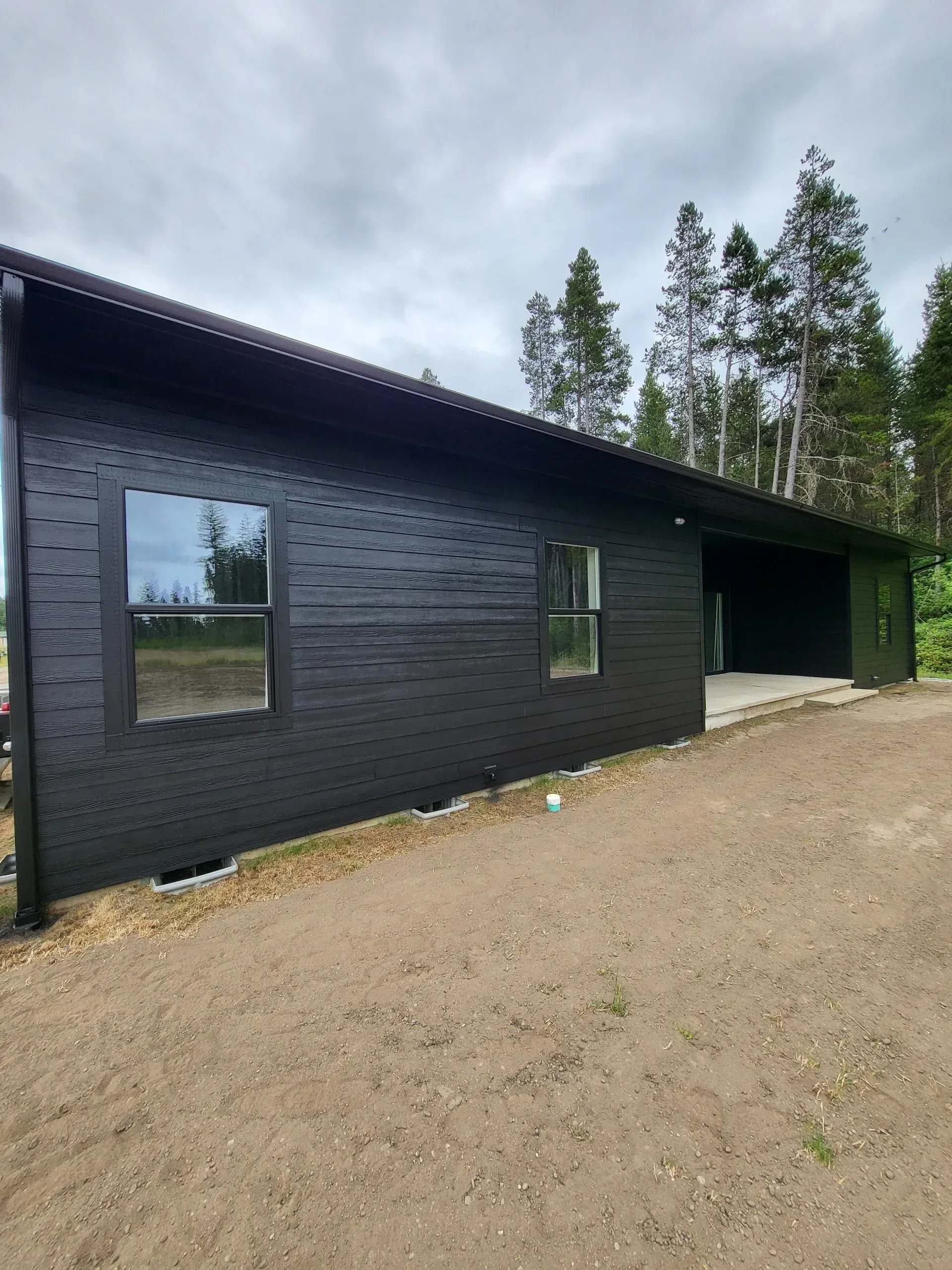 Home with professionally painted black siding and finished exterior