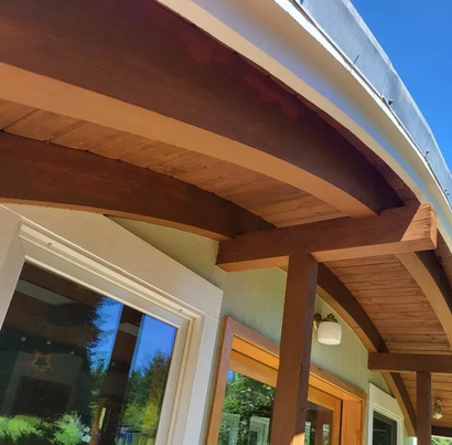 Stained wood siding and trim detail on a home exterior