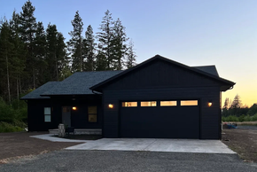 Modern custom home featuring professionally painted exterior and garage