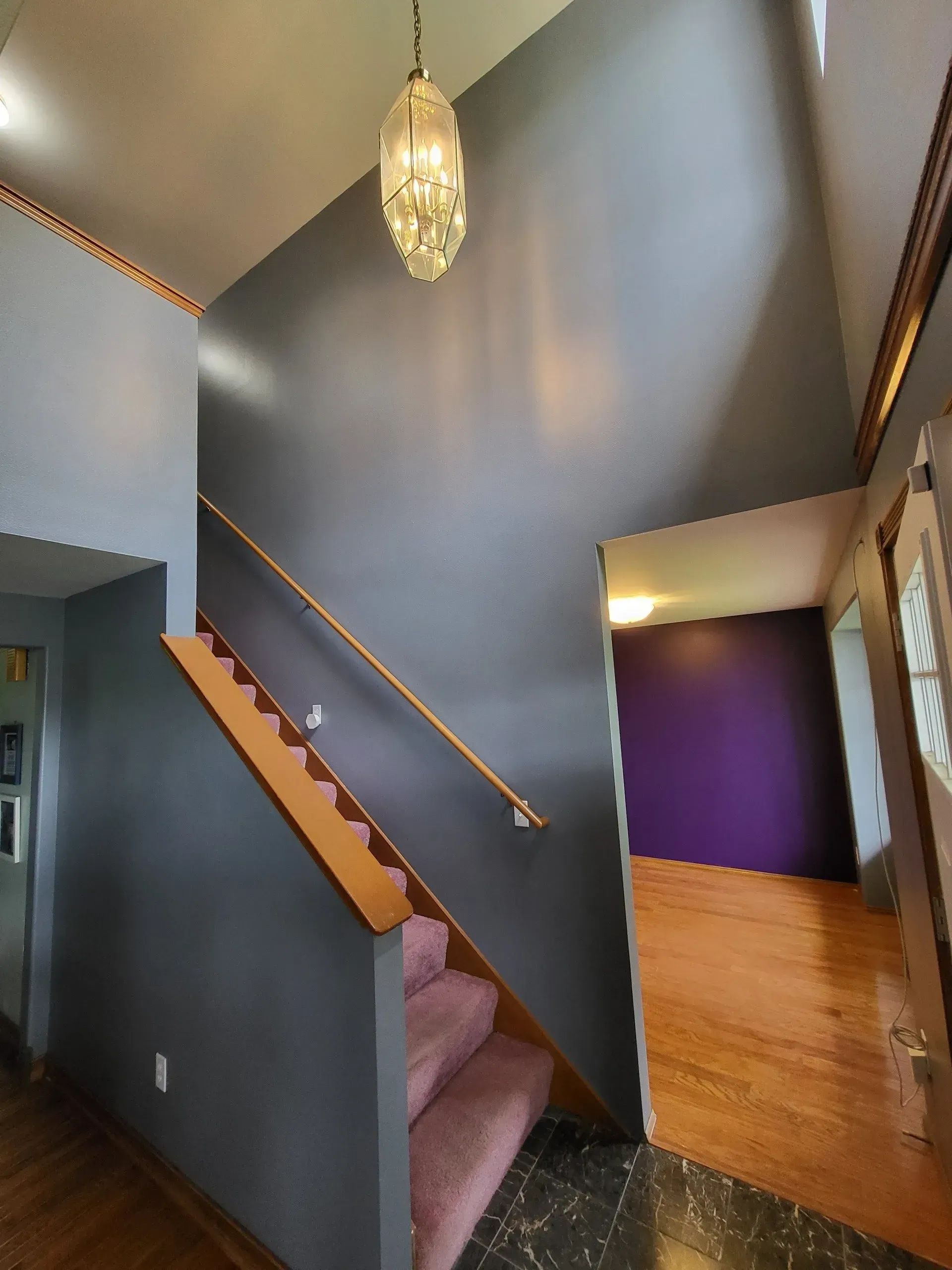 Professionally painted interior staircase and accent wall with crisp, clean finishes