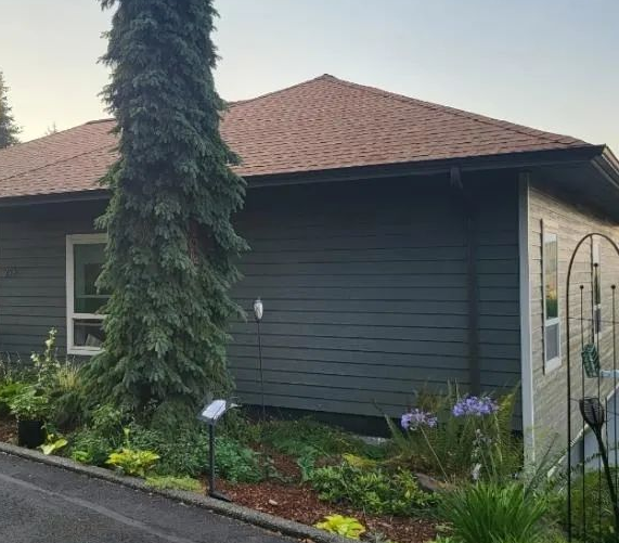 Completed exterior painting project featuring freshly painted siding and trim