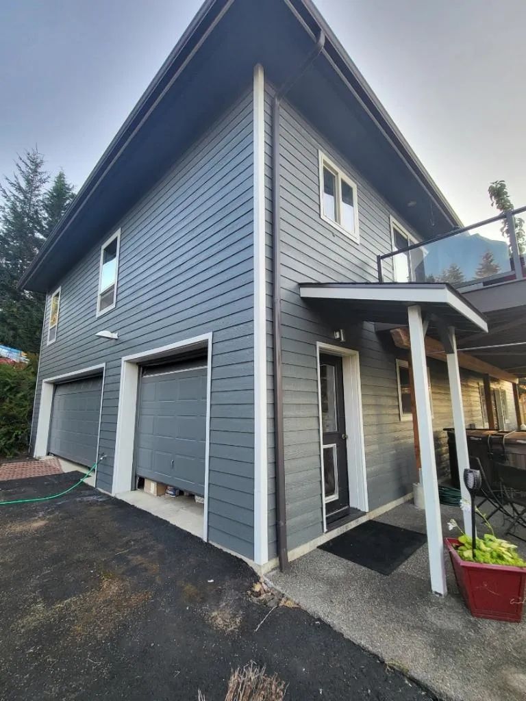 Professionally painted garage, siding, and trim with updated exterior finish