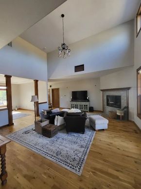 Freshly painted living room with vaulted ceilings and neutral wall colors