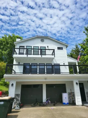 White multi-story home with professionally painted siding and trim