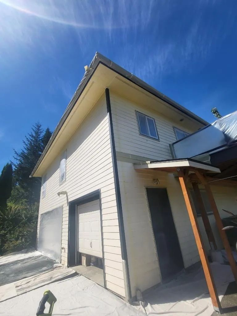 Residential garage and siding before exterior painting