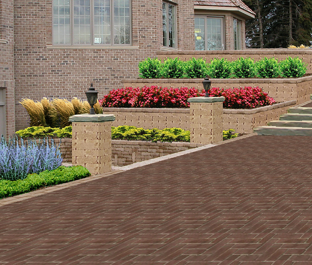 a brick driveway leading to a large brick house