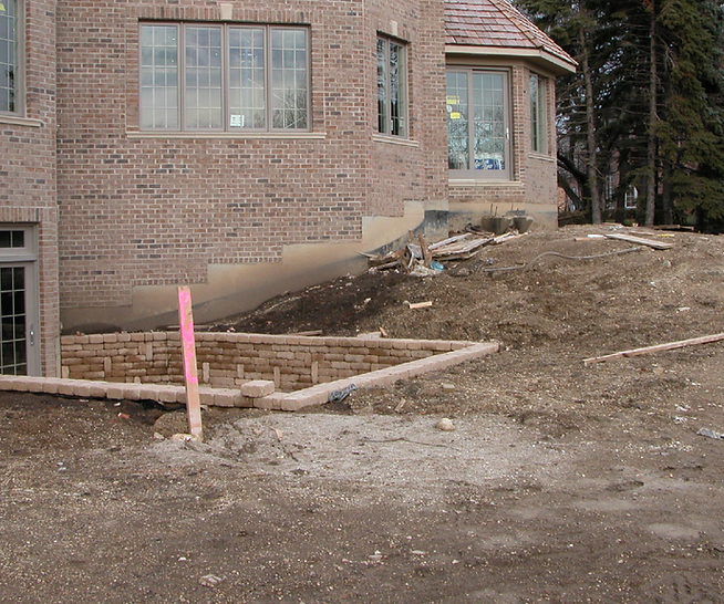a brick house with a lot of windows is being built