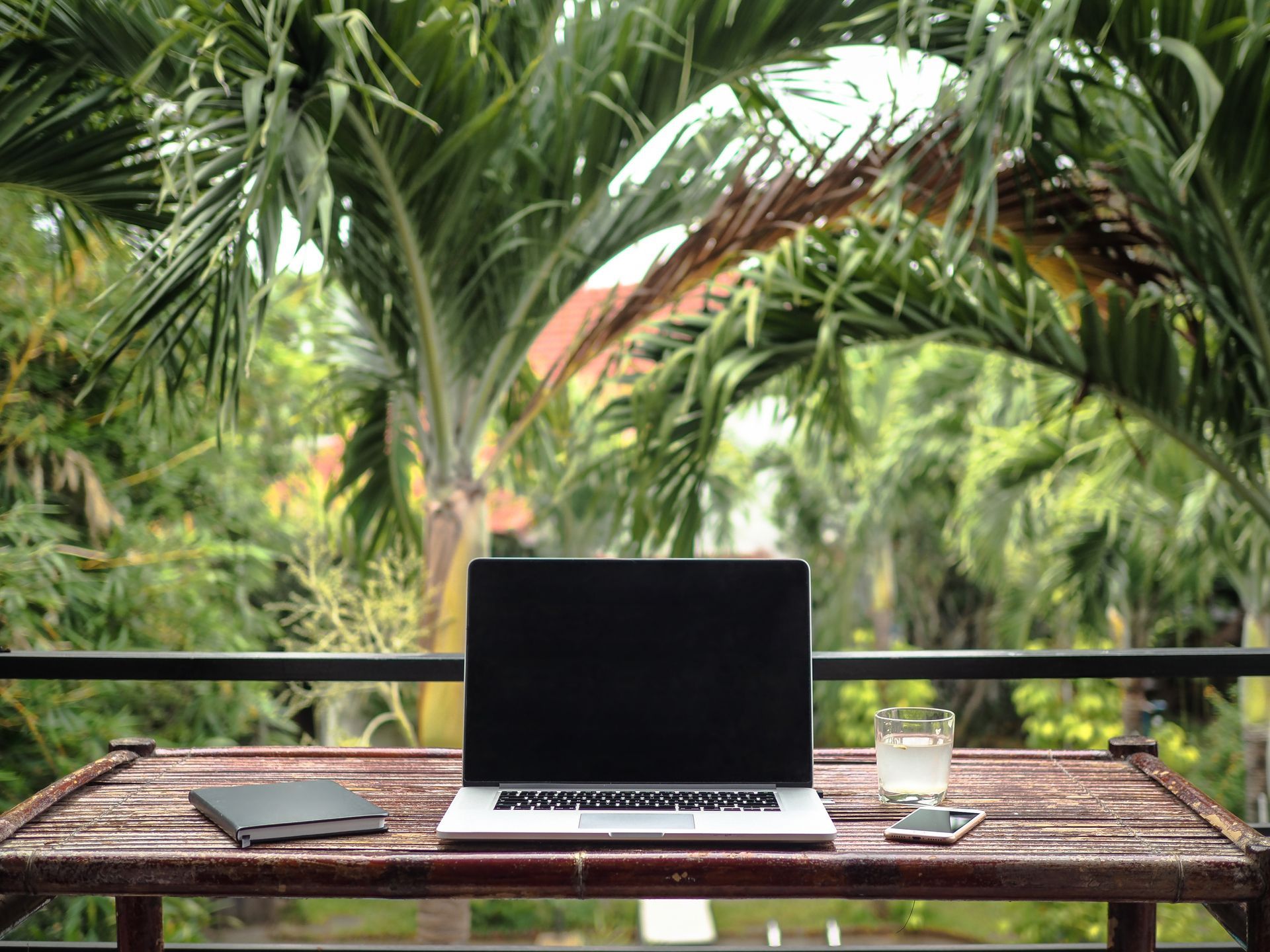 a laptop computer is sitting on top of a wooden table .