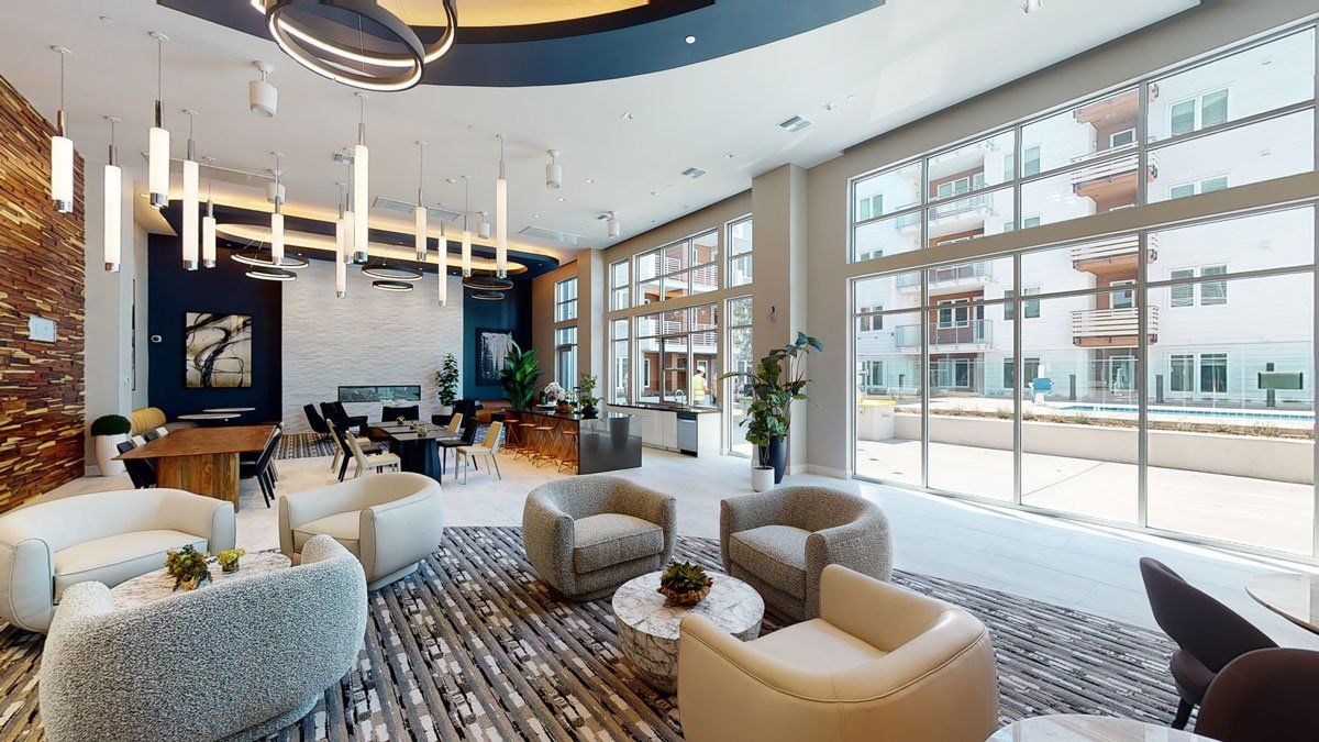A room filled with furniture and lots of windows at Capitol Towers.