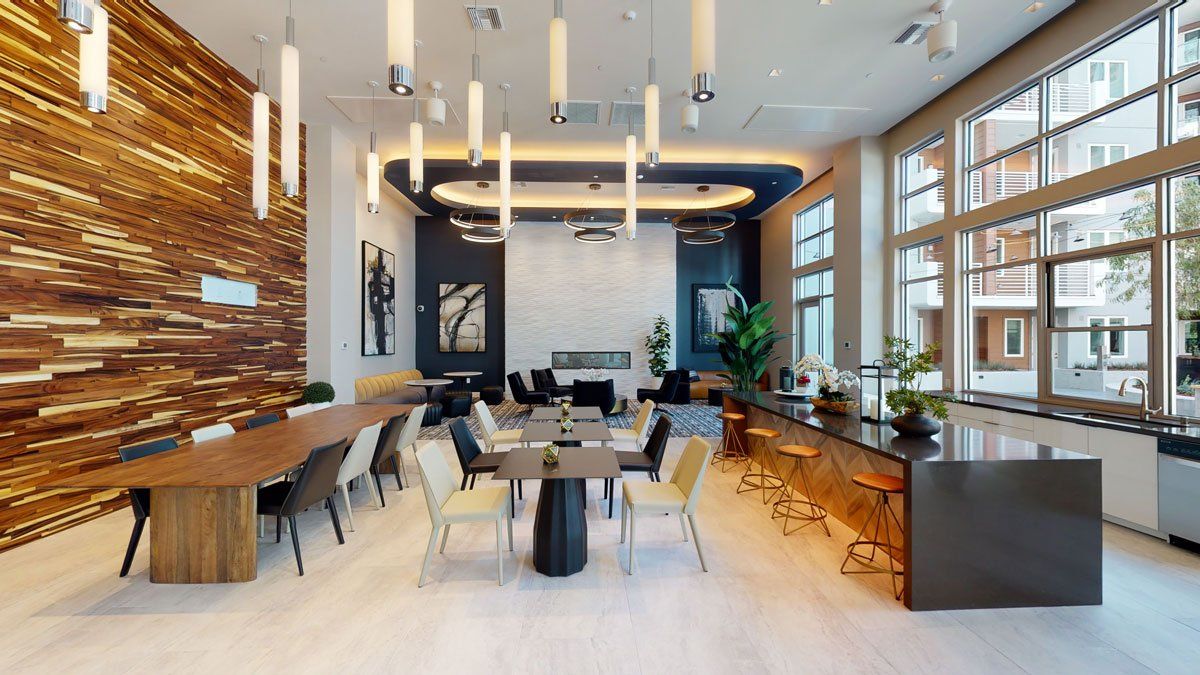 A large room with a lot of windows and tables and chairs at Capitol Towers.