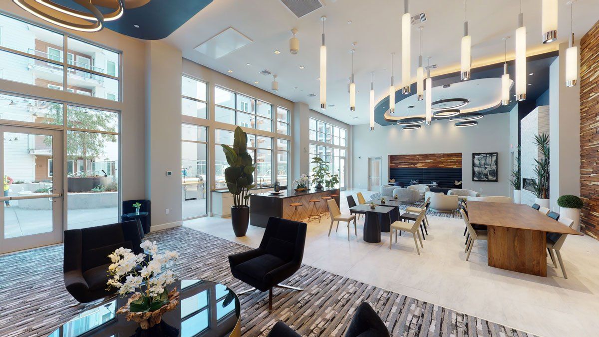 A room with a lot of furniture and a table at Capitol Towers.