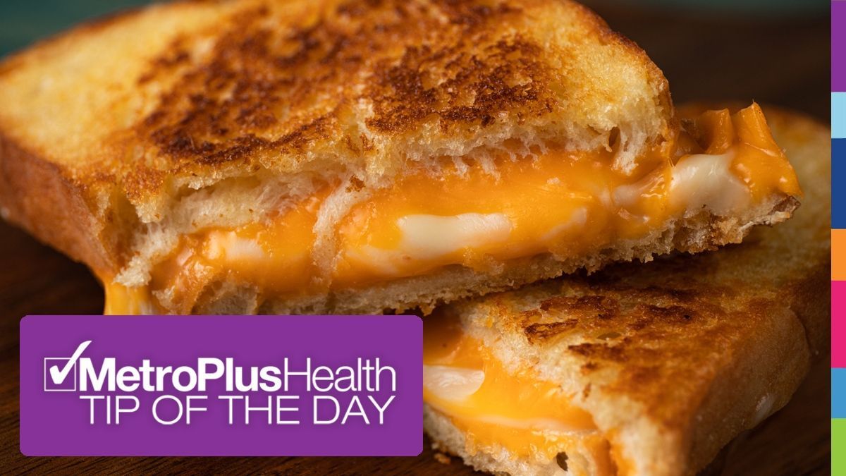 Grilled cheese sandwich, cut in half, oozing melted cheese, with MetroPlusHealth