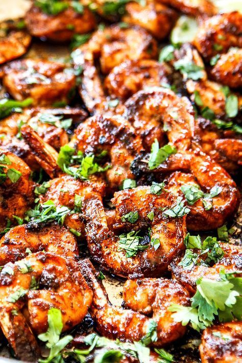 Close-up of glazed shrimp sprinkled with fresh cilantro.