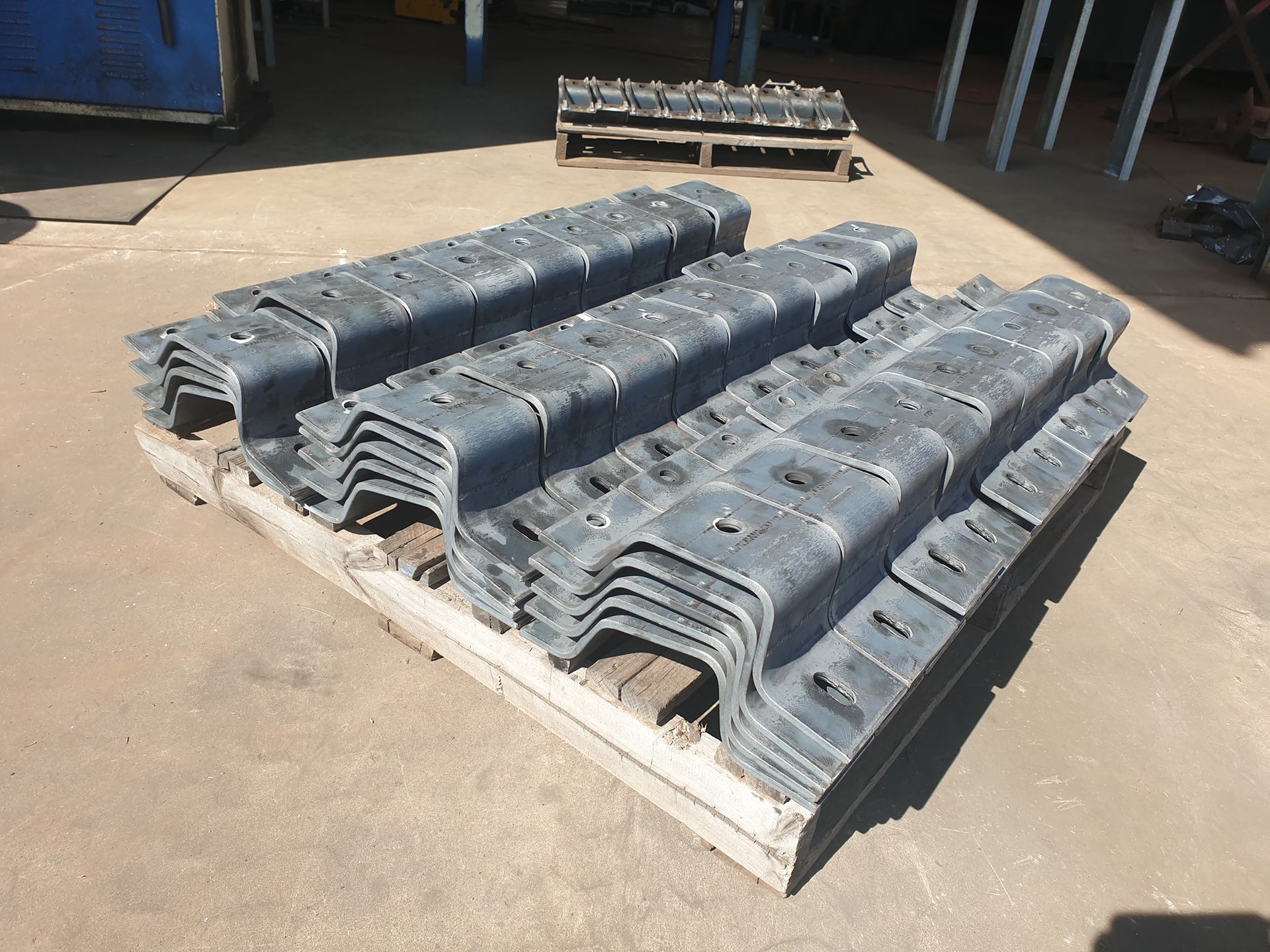 A Wooden Pallet With a Bunch of Metal Pieces on It — Roll Press NT In Tivendale, NT