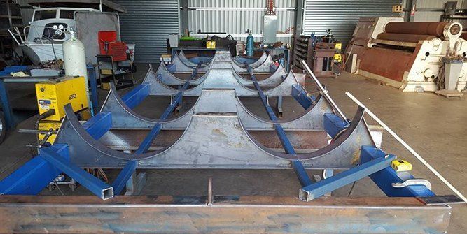 A Large Piece of Metal is Sitting on Top of a Table in a Garage — Roll Press NT In Tivendale, NT