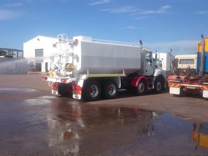 A Large White Truck is Parked in a Parking Lot — Roll Press NT In Tivendale, NT