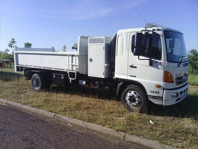 A White Truck is Parked on the Side of the Road — Roll Press NT In Tivendale, NT
