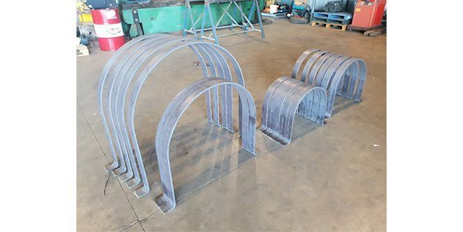 A Bunch of Metal Pipes Sitting on Top of a Concrete Floor — Roll Press NT In Tivendale, NT