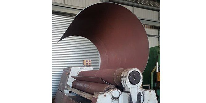 A Large Piece of Metal is Being Rolled on a Machine in a Factory — Roll Press NT In Tivendale, NT
