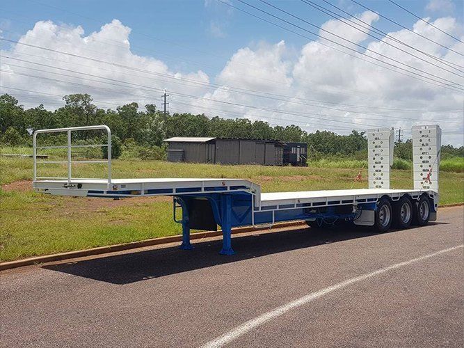 A Flatbed Trailer is Parked on the Side of the Road — Roll Press NT In Tivendale, NT