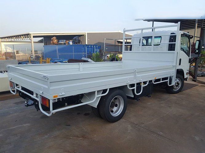 A White Truck With a Flat Bed is Parked in a Parking Lot — Roll Press NT In Tivendale, NT