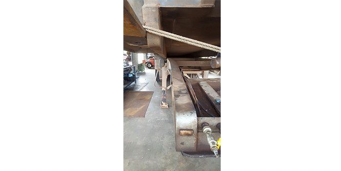 A Large Metal Machine is Sitting on Top of a Concrete Floor in a Garage — Roll Press NT In Tivendale, NT